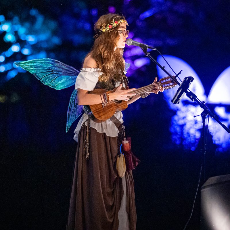 RBG After Dark - Enchanted - July 11 2024 / Tony F Media Inc. / 10156 Kat Steeves - musician dressed as a fairy playing a ukulele and singing into a mic