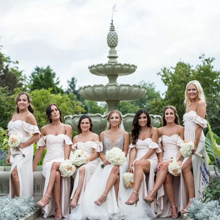 Wedding Bridal Party posing On Garden Fountain