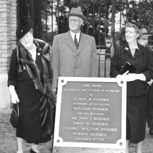 Hendrie Family Standing Behind Plaque