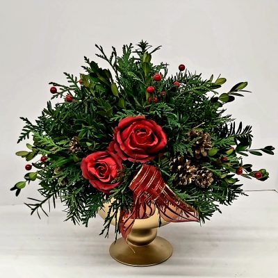 Holiday Magic - Nov 24 Holiday themed table centerpiece featuring evergreens, pinecones and berries in a large goblet-like vase