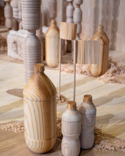 Bottles and other plastic garbage carved from wood