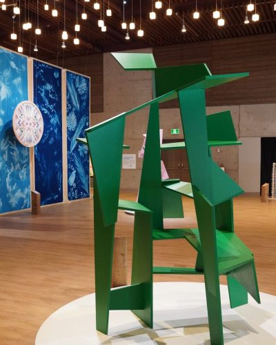 Improvised structure of reclaimed wood, painted green