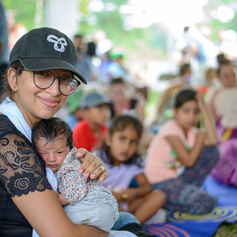 adult holding newborn baby