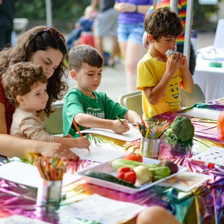 children colouring with pencil crayons in the creativity zone