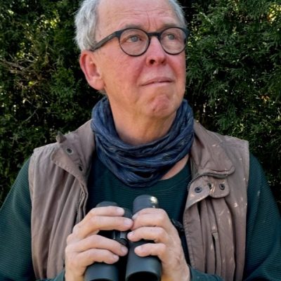 Barry Coombs Barry Coombs in nature, holding a pair of binoculars