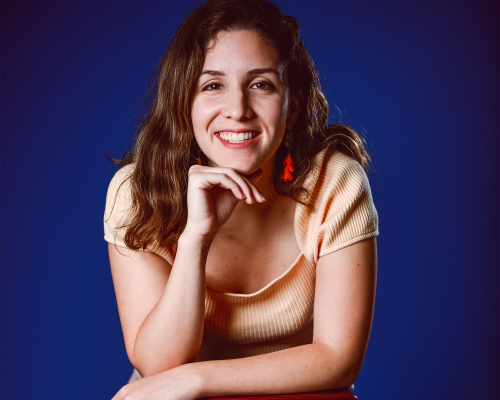 Camila_Lozada_HeadShot Camila Lozada posing in casual photos in front of a blue background