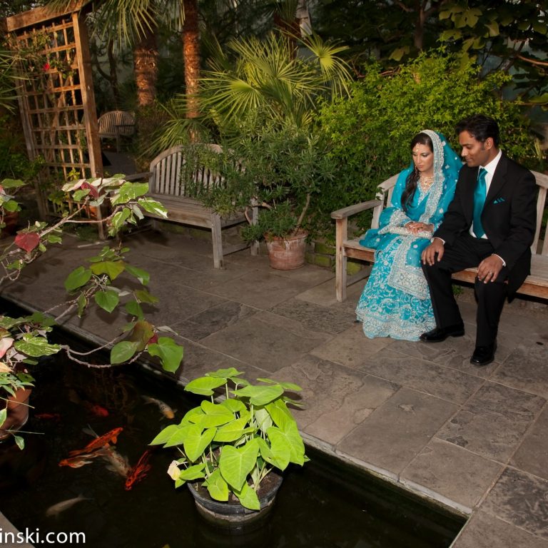 Bride and groom sitting on a bench in the Mediterranean garden