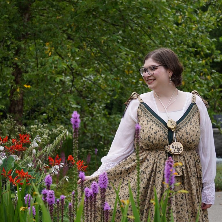person walking through rock garden dressed as a fairy