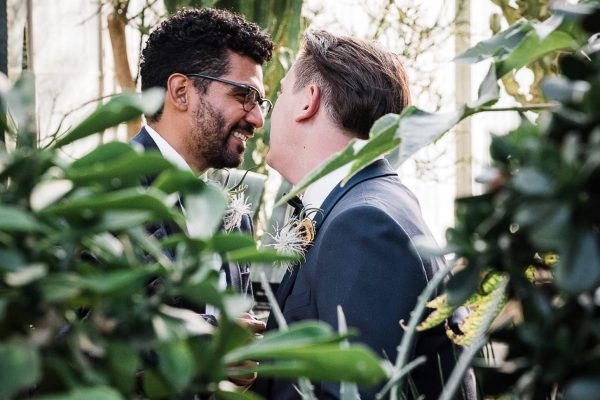 grooms-Mediterranean-garden-melissa-noelle-photography grooms romantically leaning towards each other in the Mediterranean garden