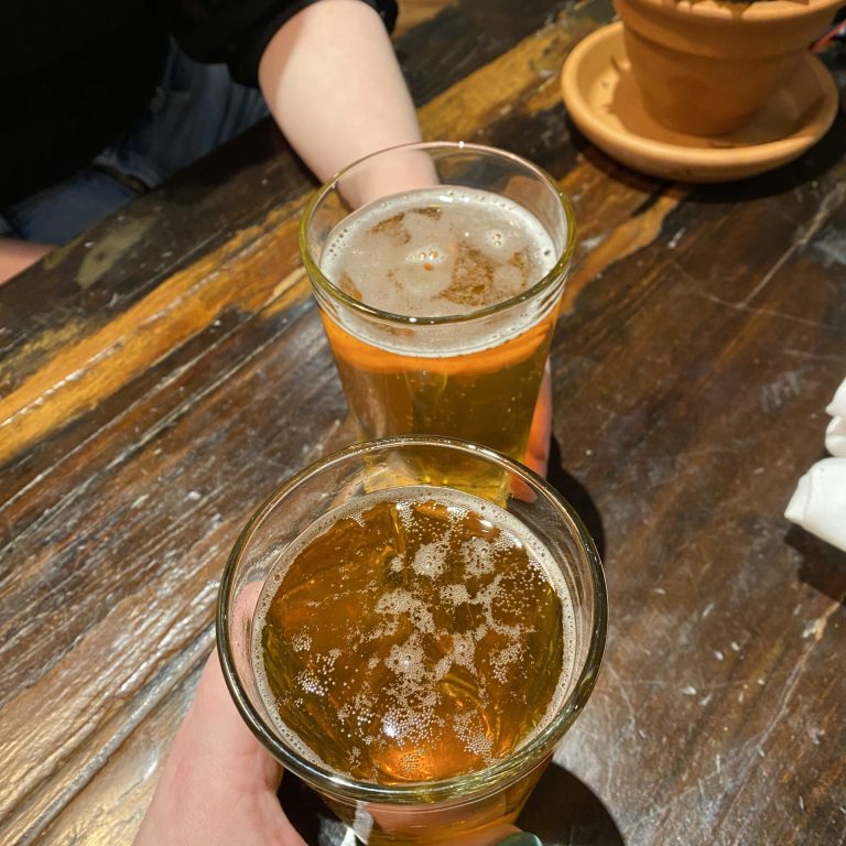 Two glasses of beer on a wooden table