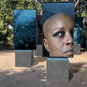 Isaac Julian CBE Stones against diamonds - Ice Cave Augmented reality artwork, frames on stone-looking pedestals featuring an ice cave and a woman's face
