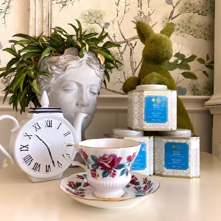 Display of tea cup, tea tins, and garden decor