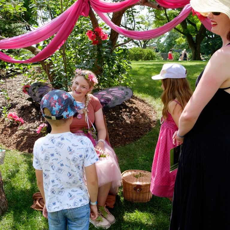 children visiting with a staff member dressed as a fairy