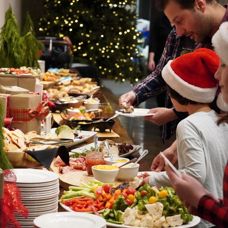 visitors taking food from a christmas buffet
