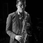 Black and white photo of a person playing the saxophone