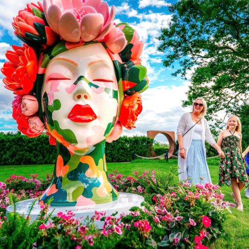Spring 26 - Royal Botanical Gardens -- Burlington - 120 Family of four looking at a Venus sculpture from artist ANCHORBALL in the garden, a woman's head with flowers covering where her hair would be, splotches of paint coming up her neck and face