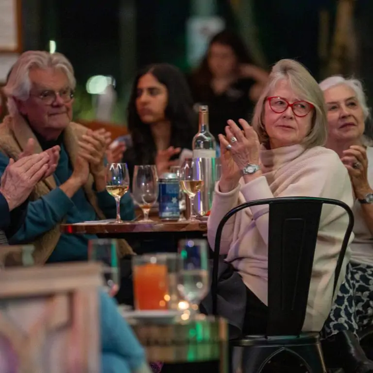 Guests clapping and enjoying a live jazz performance at WinterTide