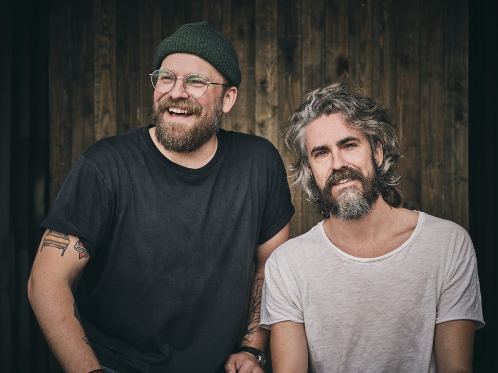 The Bros. Landreth - CREDIT Morten Fog TønderFestival 00016 The Bros Landreth Band - 2 men in tshirts against rustic background