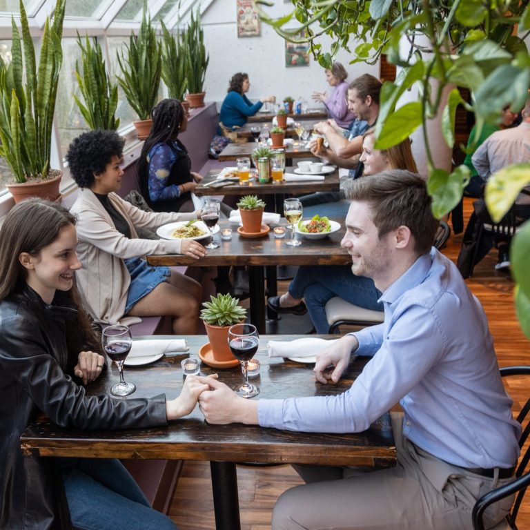 Greenhouse Café full of diners enjoying plated meals and beverages