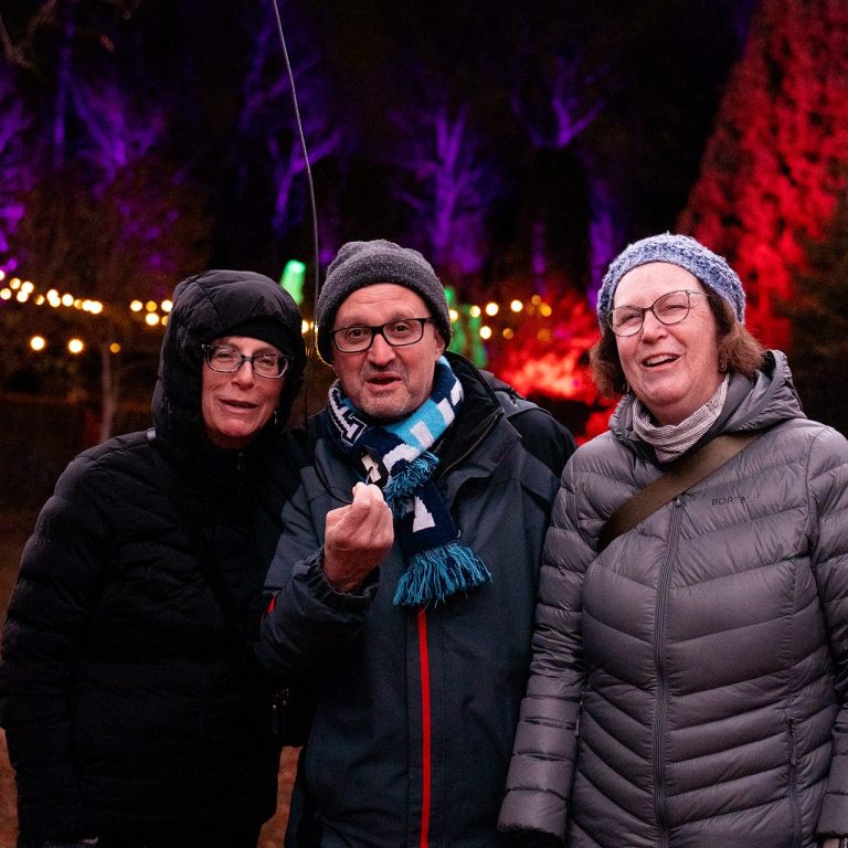 Three winter wonders videos gathered around a tiny microphone outdoors at Winter Wonders