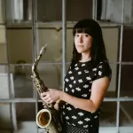 allison holding a saxophone