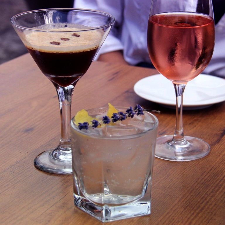 espresso martini, lavender cocktail and glass of rose wine on a bistro table