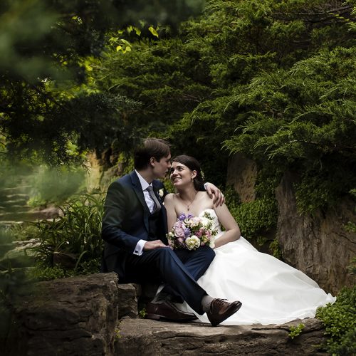 bride-groom-rock-garden-staircase-fotoflare Bride and Groom sitting on stone staircase surrounded by evergreen