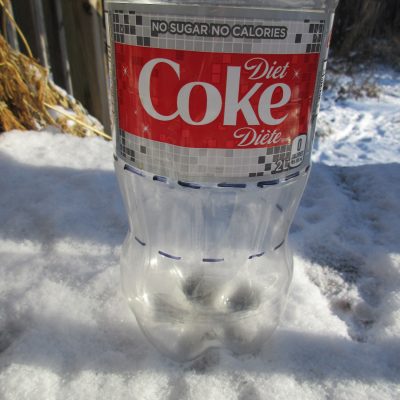 coke-bottle-scaled-2 Clear plastic diet coke bottle with dashed line around the middle and bottom of the bottle