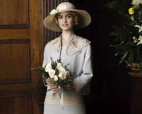 da5.36490 Downton Abbey S5 The fifth series, set in 1924, sees the return of our much loved characters in the sumptuous setting of Downton Abbey. As they face new challenges, the Crawley family and the servants who work for them remain inseparably interlinked. LILY JAMES as Lady Rose. Photographer: Nick Briggs