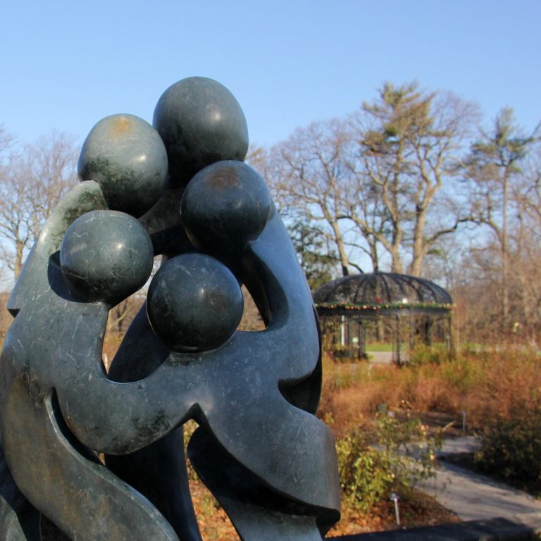 Rejoicing Family sculpture with the Rose Garden in the background