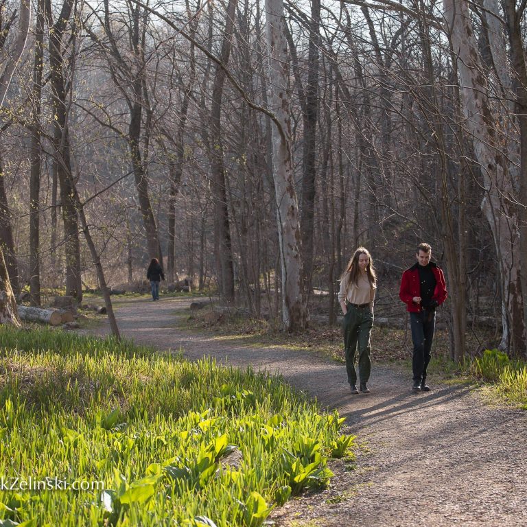 couple walking down arboretum path