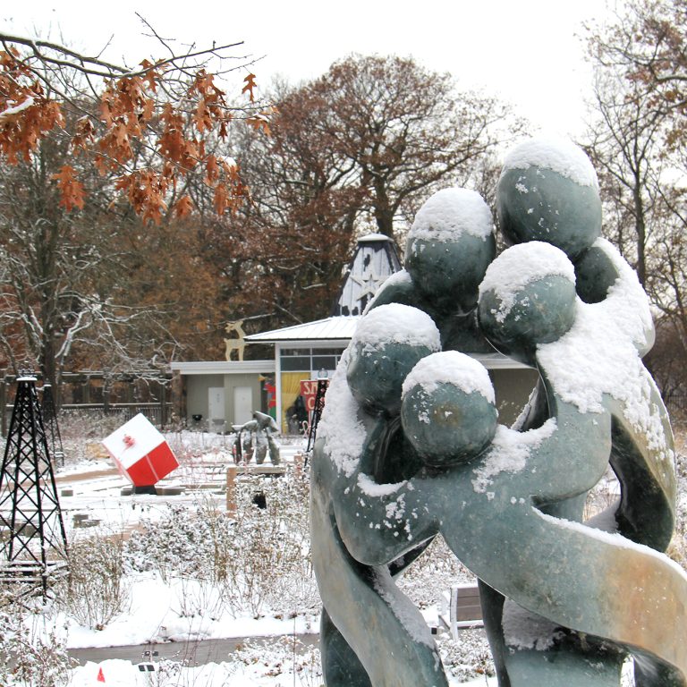 Rejoicing Family Sculpture Covered In Snow