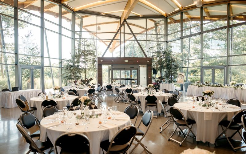Rock Garden great room set up for wedding, with full windows showing the garden outside. In Hamilton Ontario.