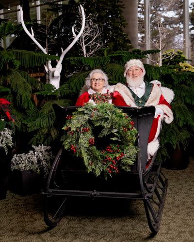 santa-sleigh-BlackDogStudios Santa and Mrs. Claus sitting in an antique style sleigh