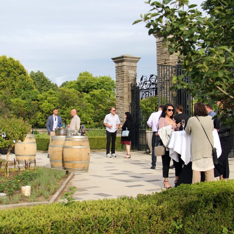 Guests enjoying wine in the scented garden of hendrie park